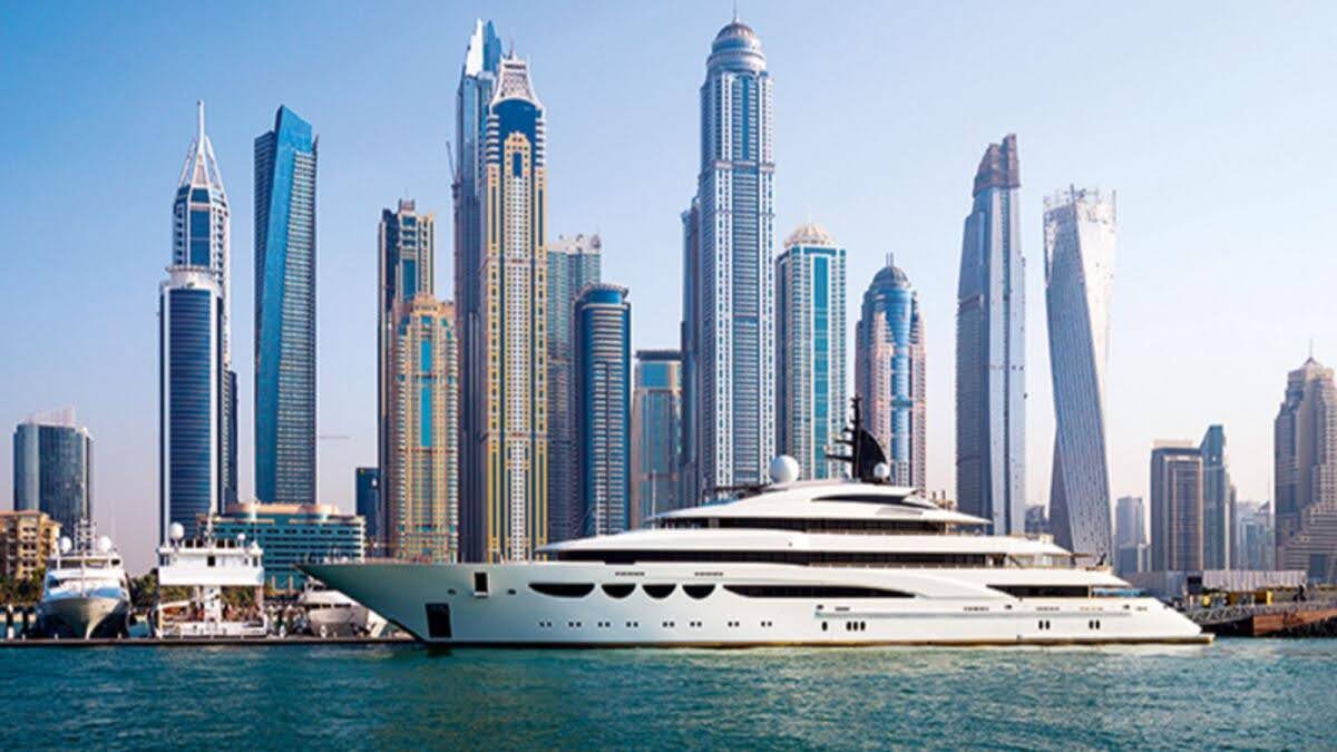White colored yacht with dubai majestic skyline in the back